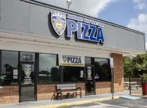 Exterior of the NYPD Pizza Winter Park restaurant with signage reading “Authentic New York Style Pizza” above the entrance.